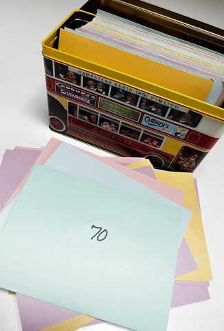 Metal tin with envelopes for savings challenge.