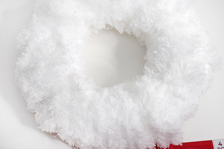 Wreath form covered in reusable dust pad looks like faux fur.