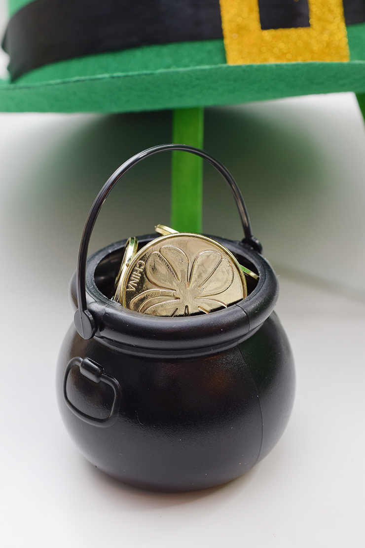 Tiny black pot filled with fake gold coins to make a trap for a leprechaun. 