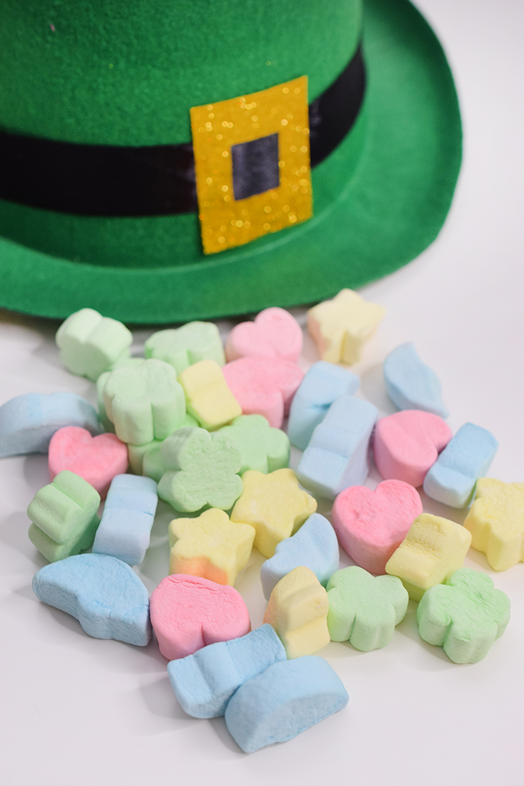 Puffy Lucky Charm marshmallows sitting by a green leprechaun hat. What the leprechaun leaves when he isn't caught in the trap.