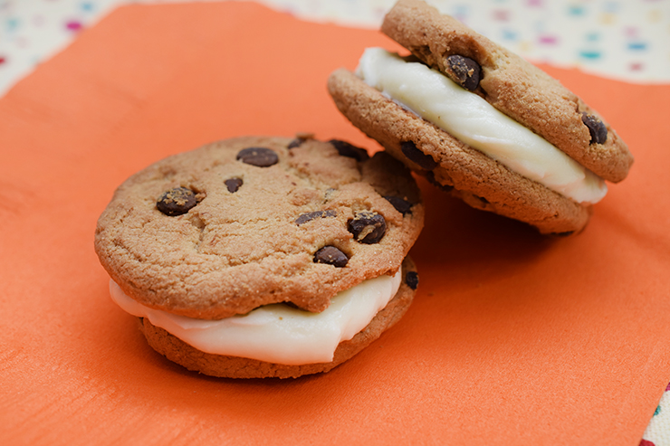 Chocolate chip cookies with homemade buttercream frosting in the middle.