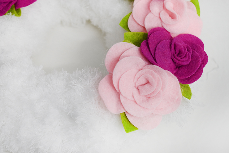 Felt flowers on faux fur wreath.