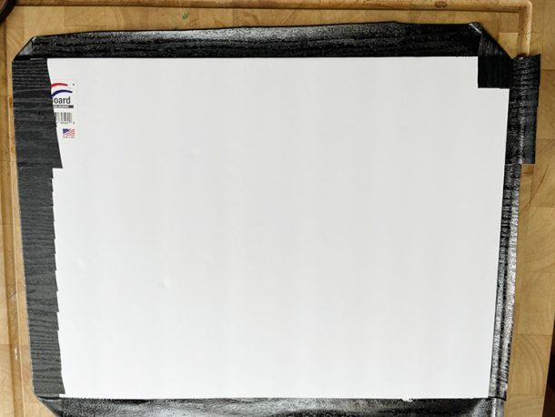 Backside of DIY photography backdrops, with contact paper edges folded over.