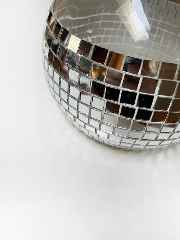 Glass bowl partially covered in small mirrors.