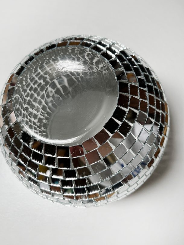 Glass bowl with mirrors all around the sides turned upside down.