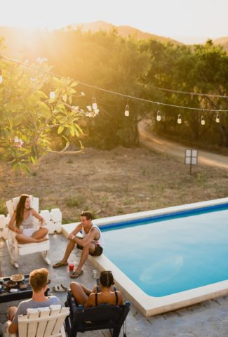 People grilling outside by the pool.
