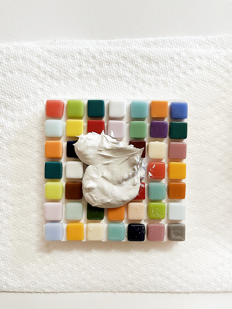 Dollop of grout on coaster.