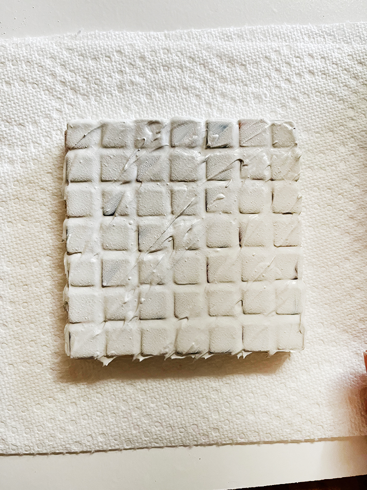 Coaster covered in grout. 