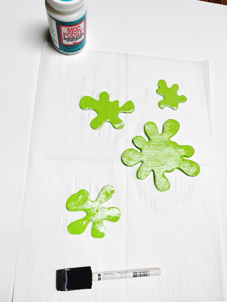 Bright green splat shapes covered with mod podge.