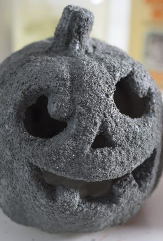 Plastic pumpkin covered in a grey, stone finish.