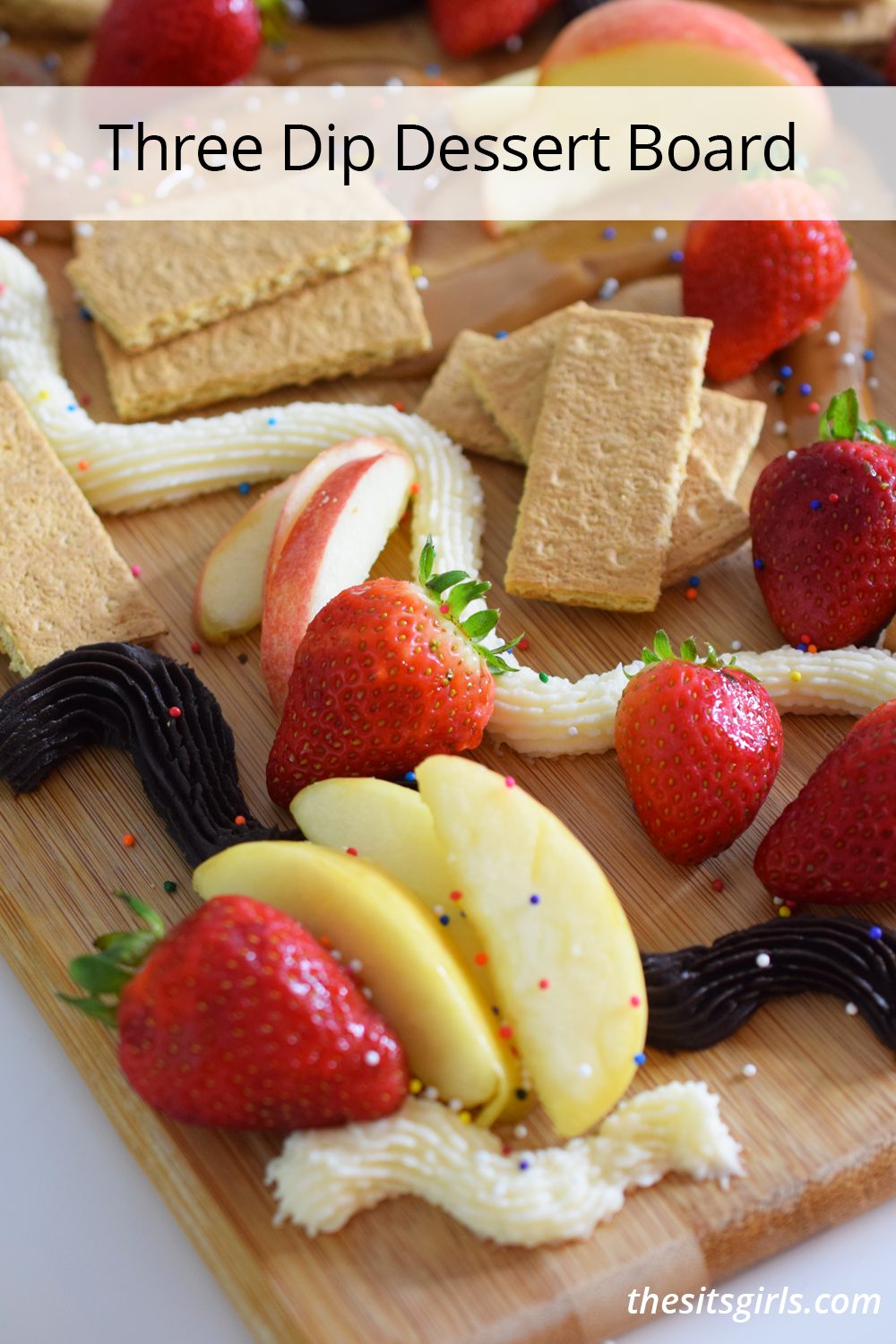 Three dip dessert board with fruit, cookies, crackers, buttercream, chocolate, and dulce de leche. 