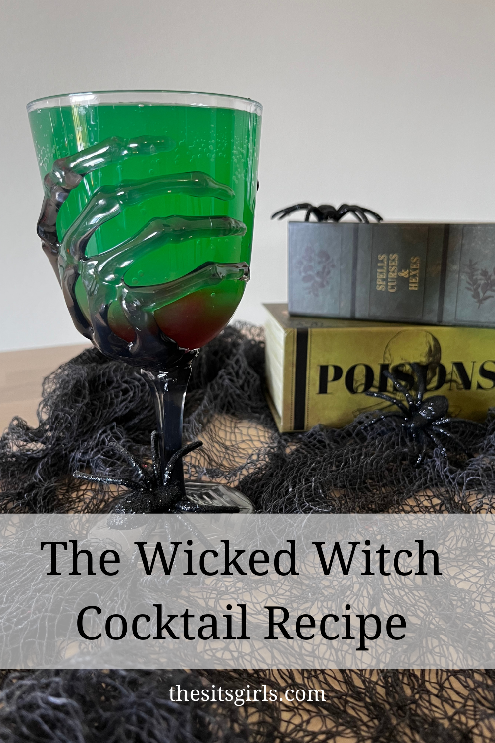 The Wicked Witch Cocktail Recipe with a photo of a green drink in a goblet with a spooky skeleton hand.
