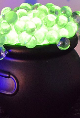 Black cauldron with bright green, glowing bubbles.